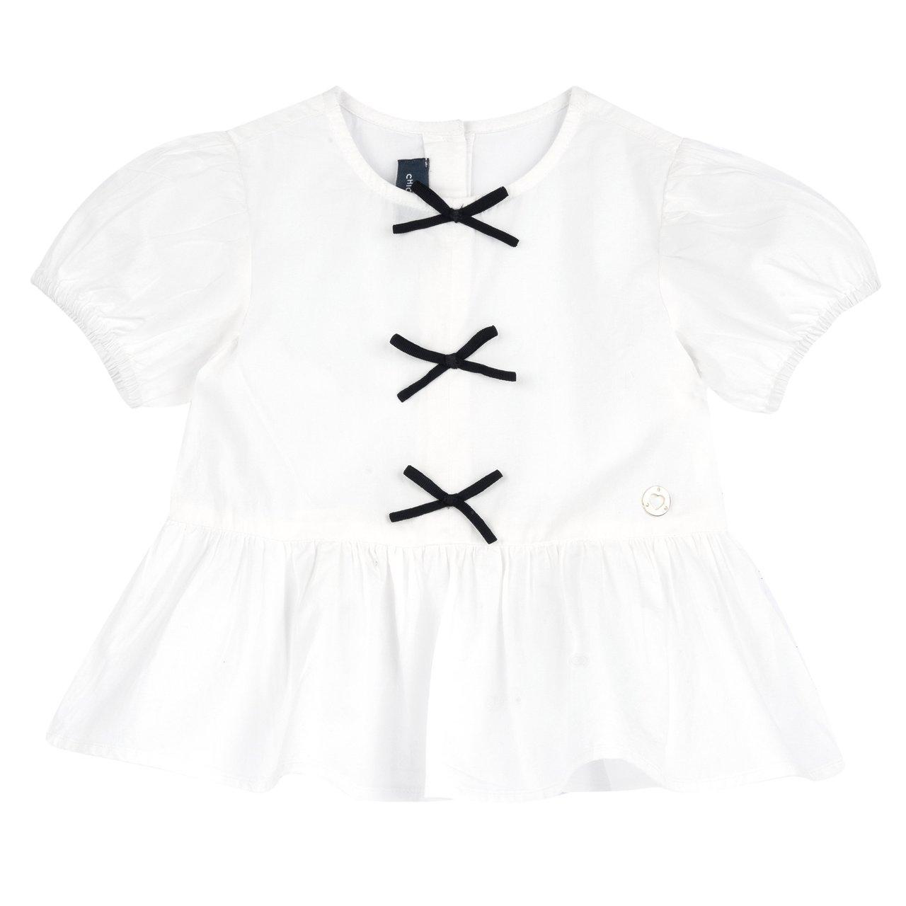 Camicia bianca a manica corta con balza e fiocchetti in nastro canneté per bambina, con maniche a palloncino e medaglietta a cuore. | Chicco