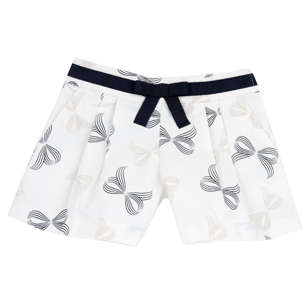 Pantaloni corti stampati bianchi da bambina Chicco in piquet elasticizzato con fiocchi bicolori e finta cinturetta, vita regolabile e zip laterale. | Chicco