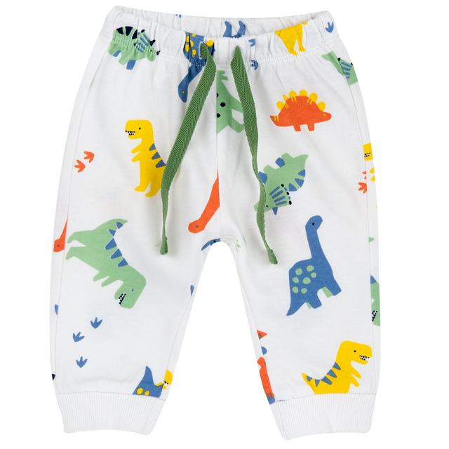 Pantaloni lunghi in cotone Chicco per bambino con fantasia multicolor di dinosauri su base bianca, vita elasticizzata e fondi a costina. | Chicco