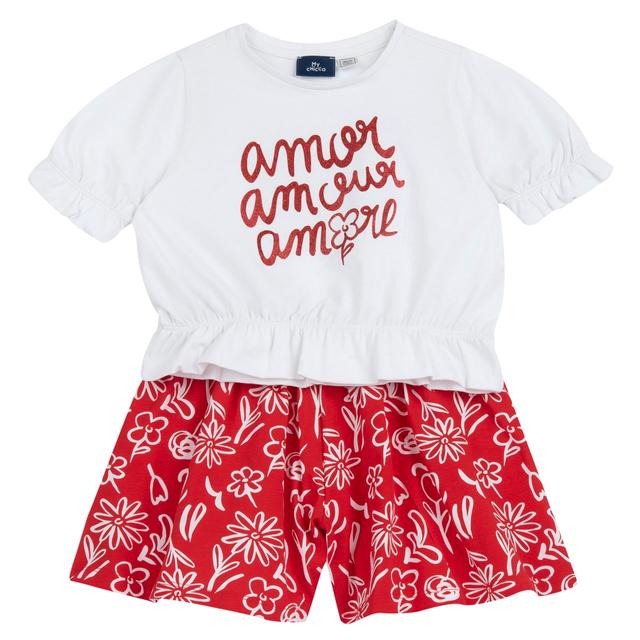 Completo estivo Chicco per bambina in cotone sostenibile, maglietta rossa con stampa glitter e pantaloni corti fantasia. | Chicco