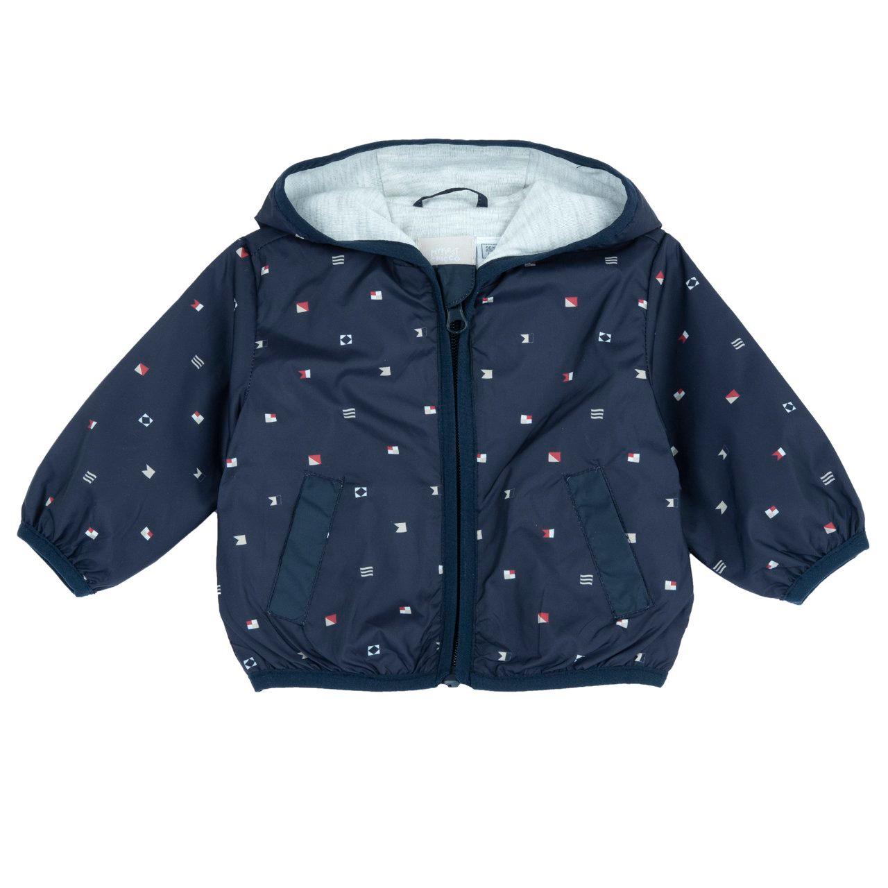 Giubbino antivento Chicco per bambino con stampa fantasia di dinosauri su sfondo azzurro, ideale per primavera/estate. | Chicco