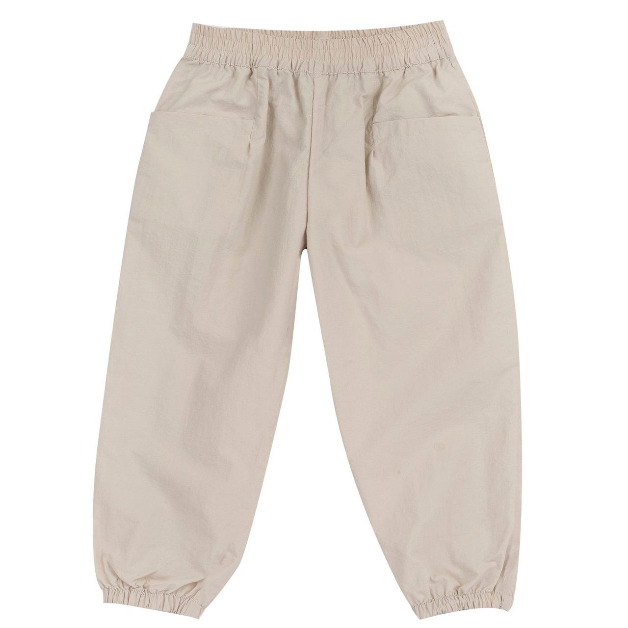 Pantaloni lunghi unisex Chicco bianchi in poliammide, con vita e fondo elasticizzati e tasche frontali, in vestibilità baggy fit. | Chicco