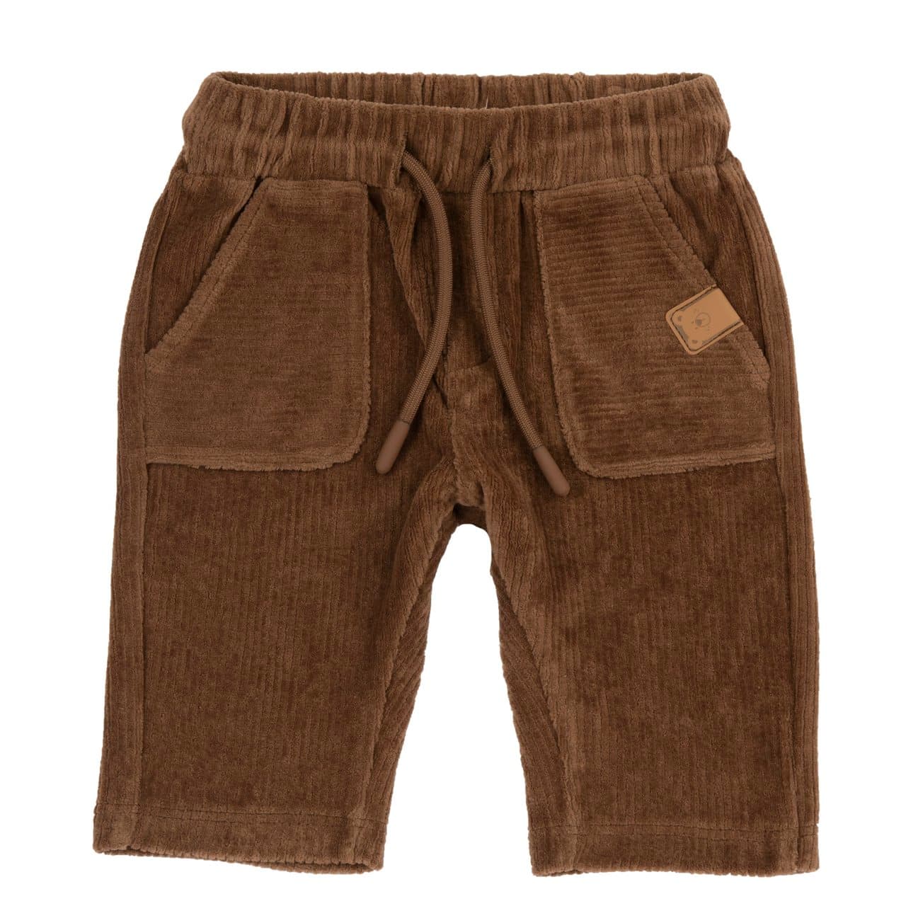 Pantaloni lunghi da bambino Chicco in ciniglia effetto velluto marrone, con tasche ampie sul davanti e etichetta applicata. | Chicco