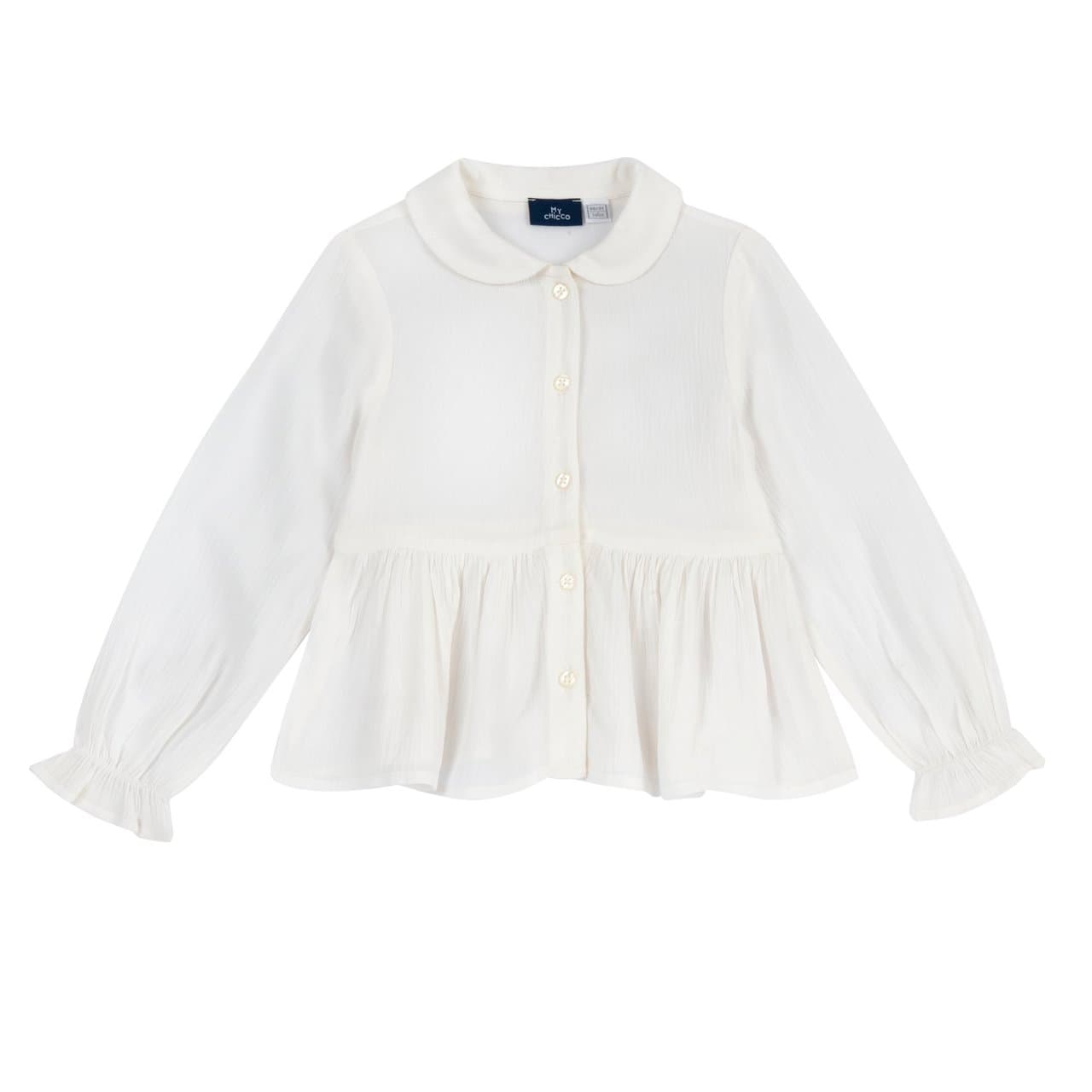 Camicia manica lunga Chicco bianca in crêpe di viscosa per bambina, con collo rotondo, balza arricciata in vita e polsini elasticizzati con rouches. | Chicco