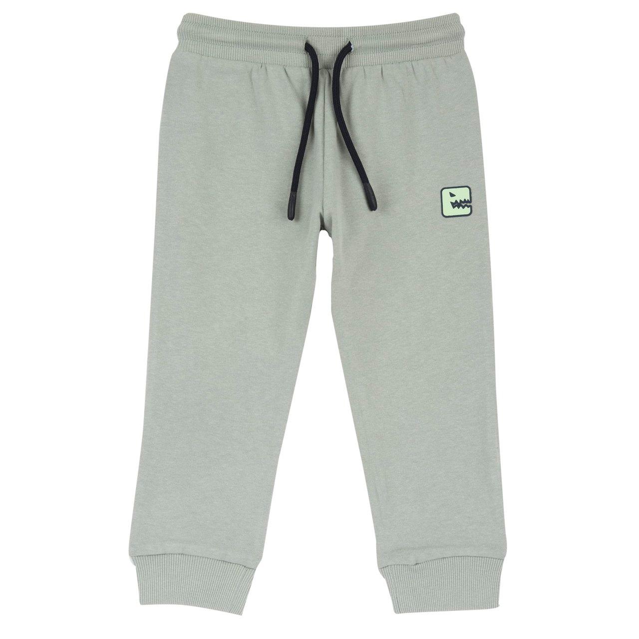 Pantaloni Lunghi | Chicco Pantaloni jogger Chicco verdi in felpa garzata per bambino, con stampa dinosauro gommata, vita elasticizzata e cordino, ideali per autunno/inverno. | Chicco